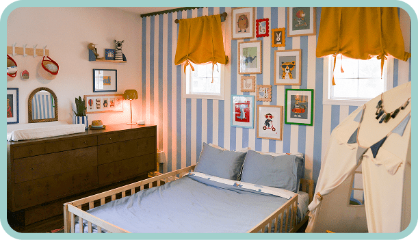 Cozy bedroom with striped walls, framed pictures, and soft lighting.