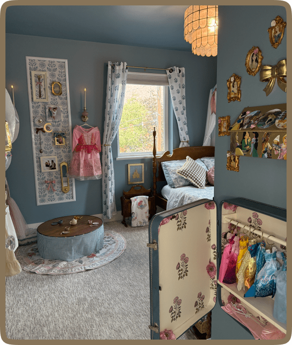 Cozy, vintage-inspired bedroom with blue walls and eclectic decor.