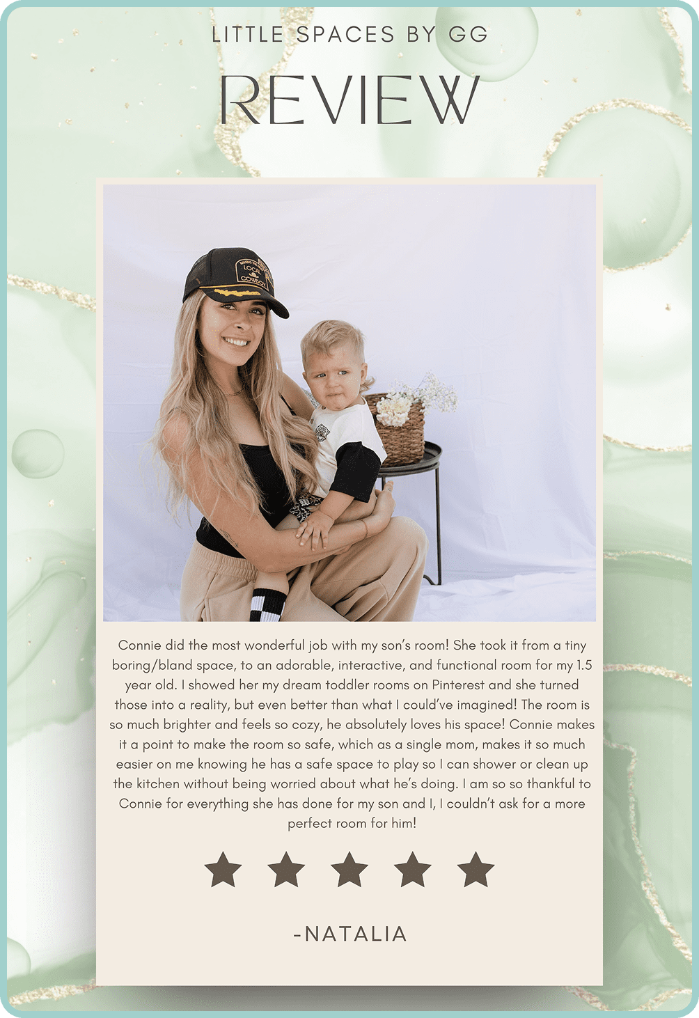 A young woman and child smiling with a black dog against a white backdrop.