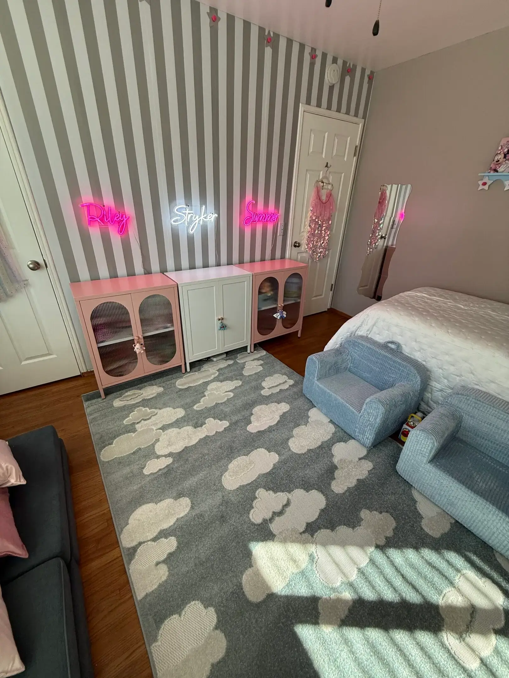 A cozy bedroom with soft lighting and pastel decor.